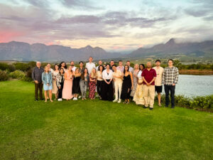 PMBA students pose in front of a sunset in South Africa.