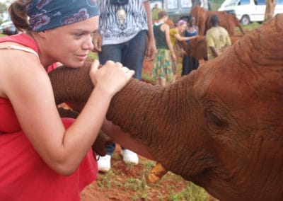 Girl holding an elephants trunk