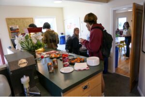 People taking food off a countertop at the Garage