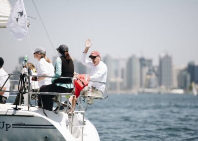 man waving from sail boat