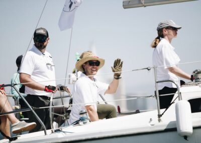 people waving from sailboat