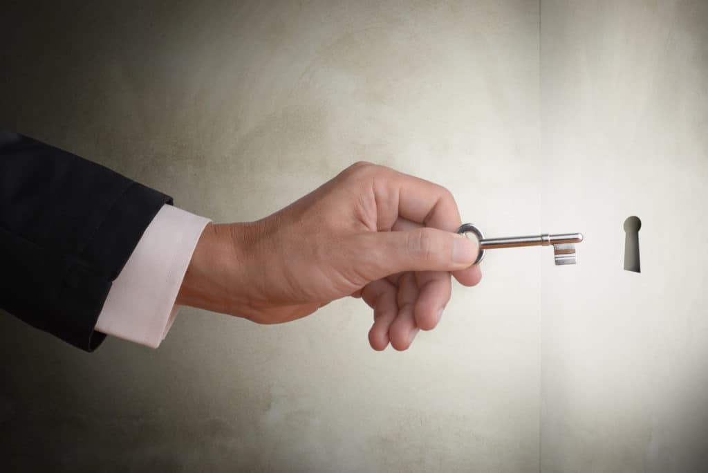 business man holding key