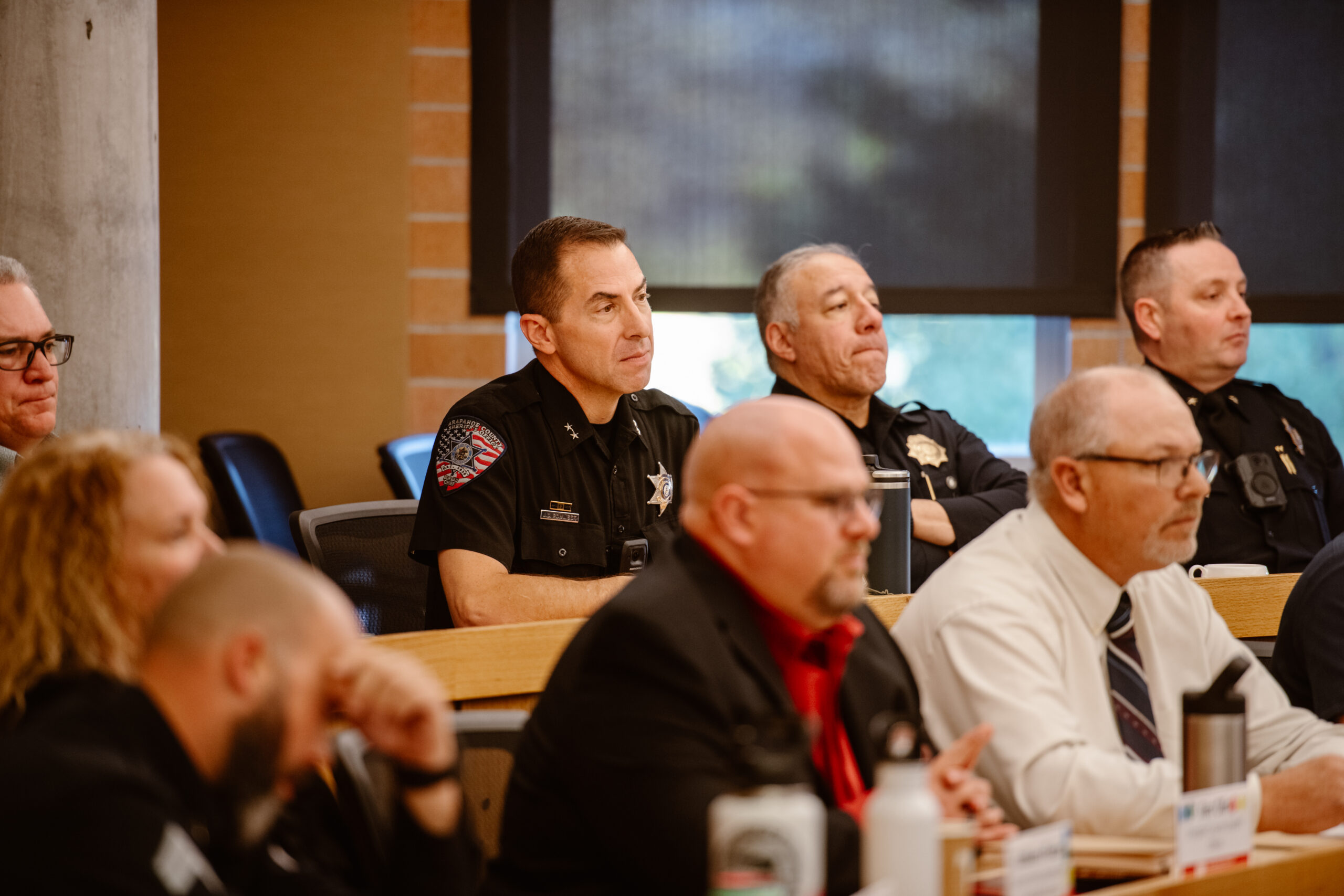public safety officials listening intently at PSLD graduation ceremony at DU