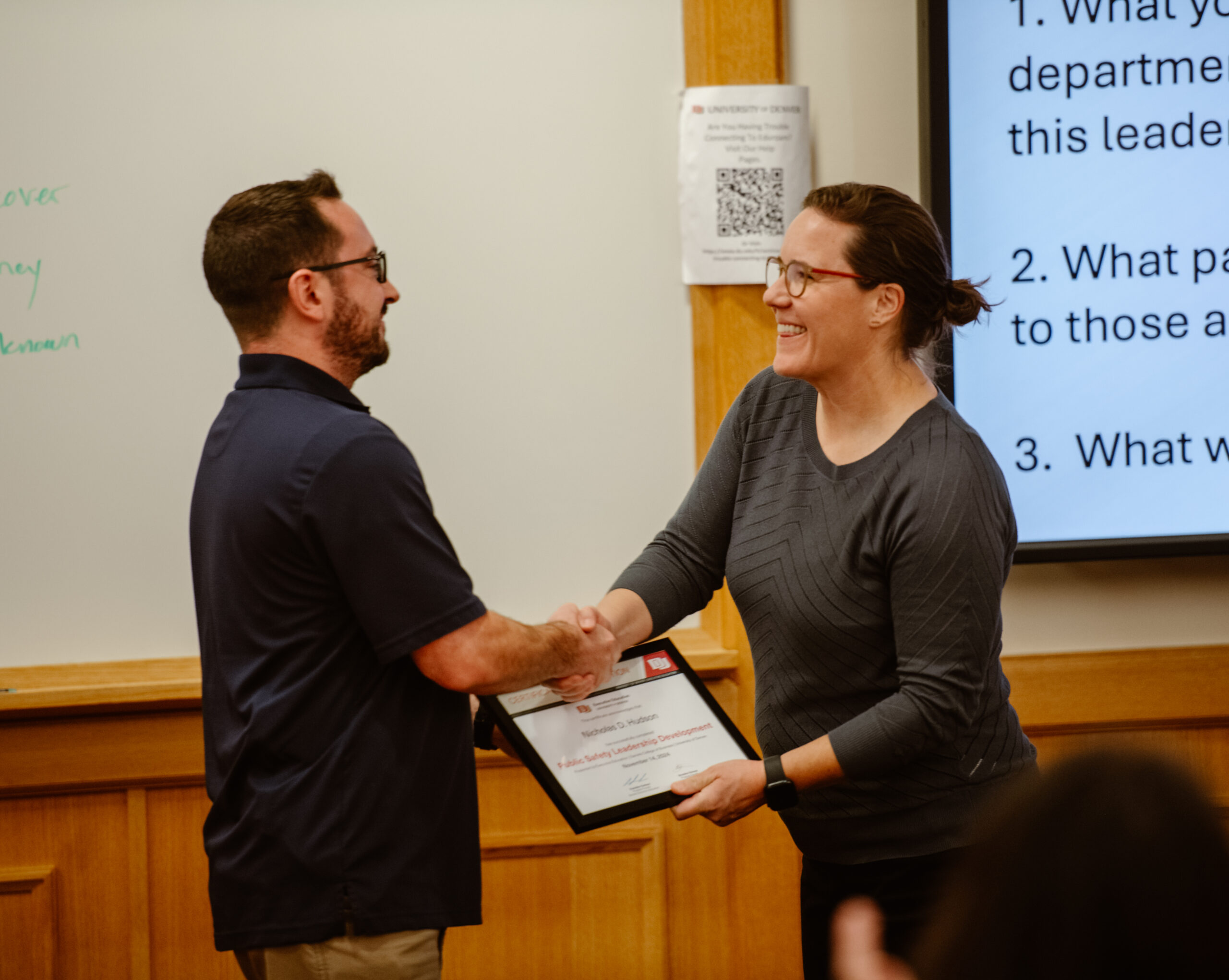 PSLD Graduate shakes Program Faculty Cassidee Carlson's Hand
