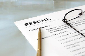 Closeup of resume with pen and glasses on the table