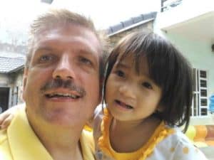 Jim Altman poses for a photo with a Vietnamese orphan. This shot, he says, "became our family vision for international adoption"