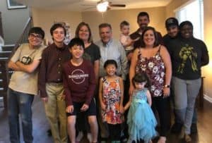 Jim Altman, center, with his family, including adopted children Samuel and Caylie in the front row.